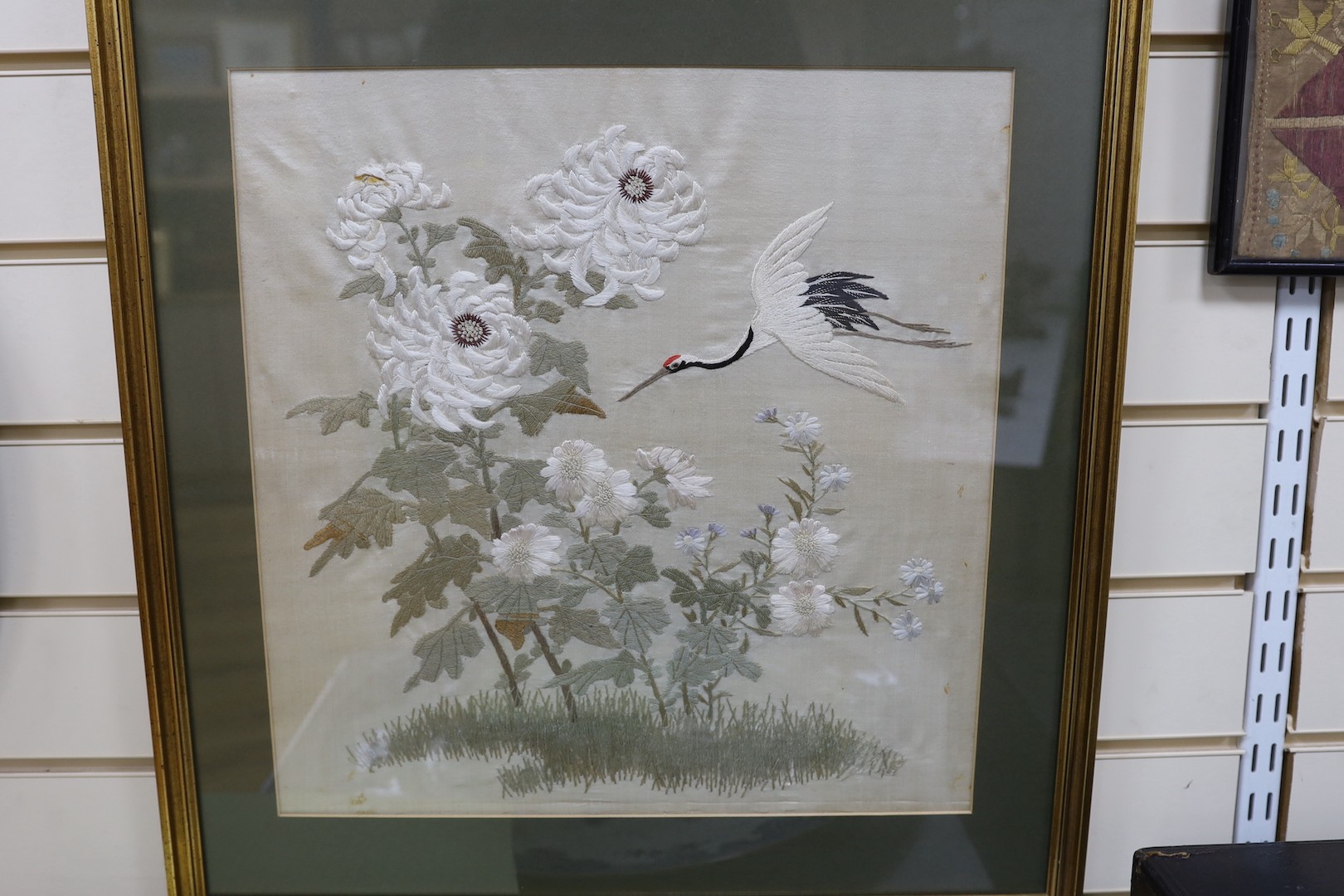 A pair of late 19th century Japanese silk work panels of heron amongst foliage - 41.5 x 41cm